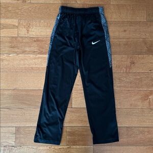 Nike Dri-Fit boys black athletic pants size M with pockets.
